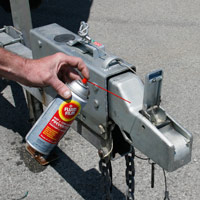 Man applying Fluid Film on Boat trailer