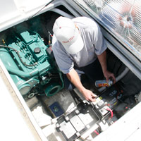 Man applying Fluid Film on boat electronic equipment