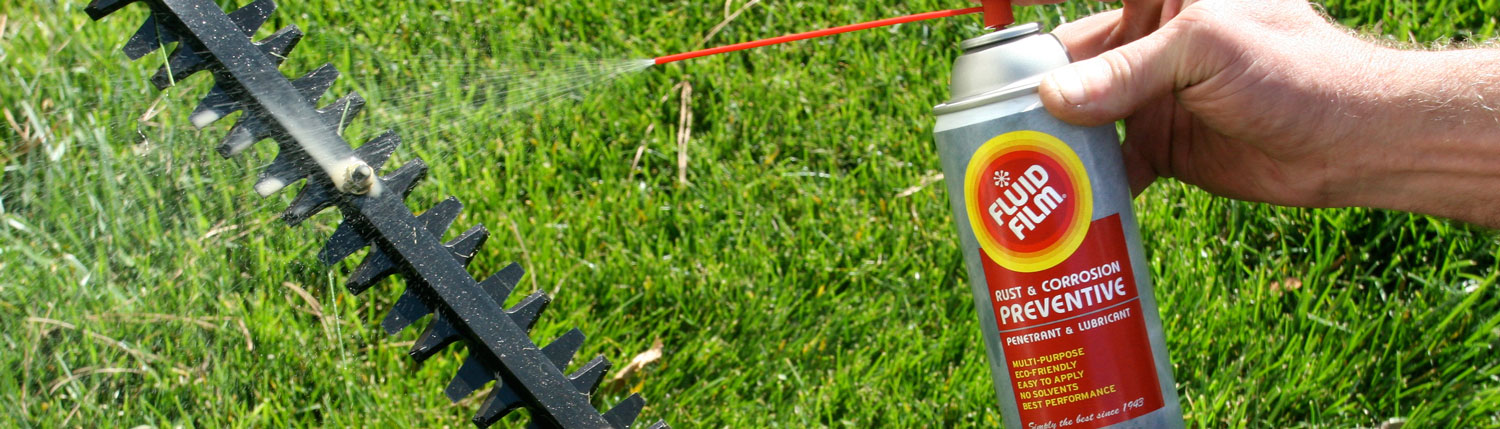 Man applying Fluid Film on hedge trimmer