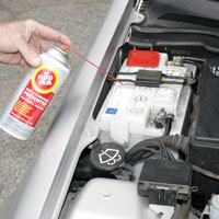 battery-terminals Man applying Fluid Film on Automobile battery terminal