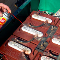 Man applying Fluid Film on Agriculture truck battery terminal