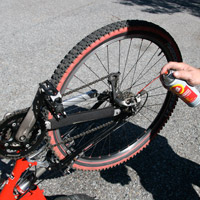 Man applying Fluid Film on bicycle chain