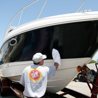 Man applying Fluid Film on boat's exposed metals