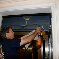 Man applying Fluid Film on electric door