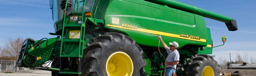 Man sprying Fluid Film on farming truck