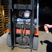 Man applying Fluid Film on Material Handling machine