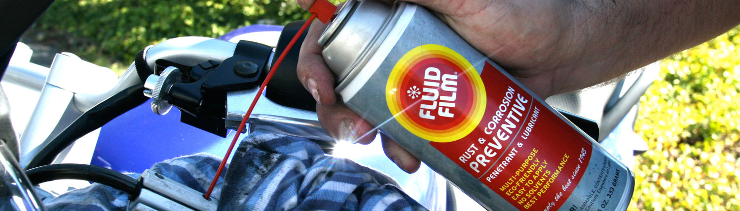 Man applying Fluid Film on Motorcycle brakes