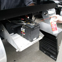 Man applying Fluid Film on truck battery terminal