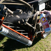 Man applying Fluid Film on winterized garden machine